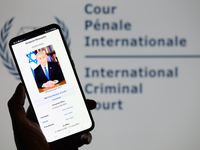 Benjamin Netanyahu appears on a smartphone with the International Criminal Court logo visible in the background in this photo illustration i...