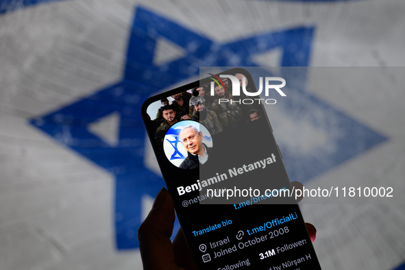 Benjamin Netanyahu's social media is displayed on a smartphone with the flag of Israel visible in the background in this photo illustration...