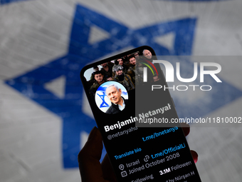 Benjamin Netanyahu's social media is displayed on a smartphone with the flag of Israel visible in the background in this photo illustration...