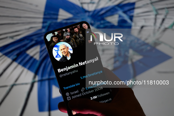 Benjamin Netanyahu's social media is displayed on a smartphone with the flag of Israel visible in the background in this photo illustration...