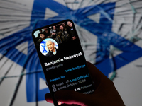 Benjamin Netanyahu's social media is displayed on a smartphone with the flag of Israel visible in the background in this photo illustration...