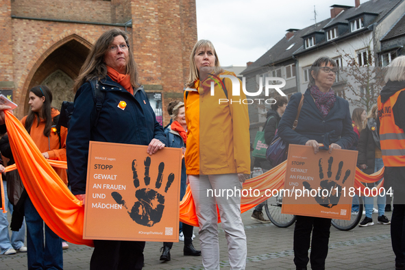 A hundred participants take part in a demonstration for International Women's Day in Bonn, Germany, on November 25, 2024, to raise awareness...