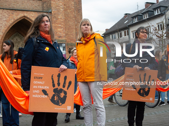 A hundred participants take part in a demonstration for International Women's Day in Bonn, Germany, on November 25, 2024, to raise awareness...