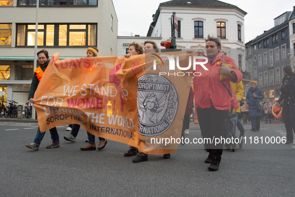 A hundred participants take part in a demonstration for International Women's Day in Bonn, Germany, on November 25, 2024, to raise awareness...