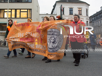 A hundred participants take part in a demonstration for International Women's Day in Bonn, Germany, on November 25, 2024, to raise awareness...