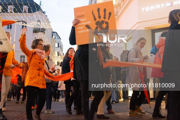 A hundred participants take part in a demonstration for International Women's Day in Bonn, Germany, on November 25, 2024, to raise awareness...