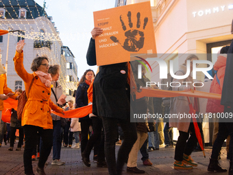 A hundred participants take part in a demonstration for International Women's Day in Bonn, Germany, on November 25, 2024, to raise awareness...