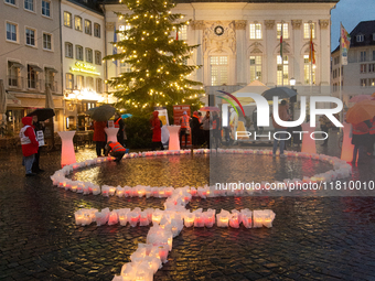 365 candles with the symbol of a woman are illuminated in front of the Townhall as hundreds of participants take part in a demonstration for...