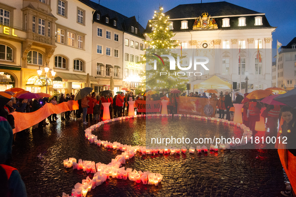 365 candles with the symbol of a woman are illuminated in front of the Townhall as hundreds of participants take part in a demonstration for...