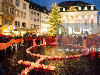 365 candles with the symbol of a woman are illuminated in front of the Townhall as hundreds of participants take part in a demonstration for...