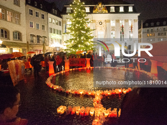 365 candles with the symbol of a woman are illuminated in front of the Townhall as hundreds of participants take part in a demonstration for...