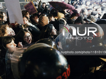 Women are surrounded by police as they demonstrate to mark the International Day for the Elimination of Violence against Women in Istanbul,...