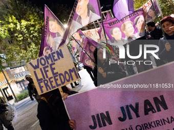 A protester holds a banner that reads 'Women Life Freedom' during a rally in front of the Greek Parliament to mark the International Day for...