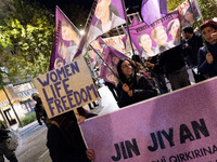 A protester holds a banner that reads 'Women Life Freedom' during a rally in front of the Greek Parliament to mark the International Day for...