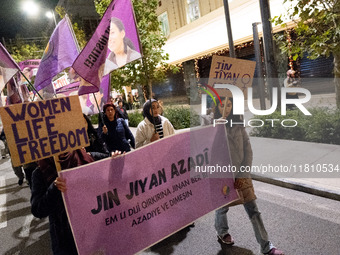 A protester holds a banner that reads 'Women Life Freedom' during a rally in front of the Greek Parliament to mark the International Day for...