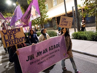 A protester holds a banner that reads 'Women Life Freedom' during a rally in front of the Greek Parliament to mark the International Day for...