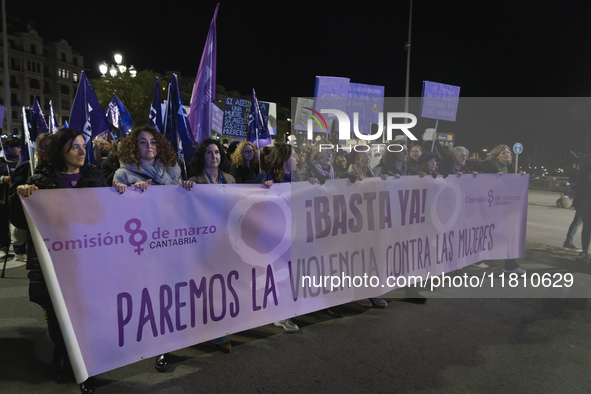 A group of women with a banner reading ''Enough, let's stop violence against women'' leads the demonstration for the International Day for t...