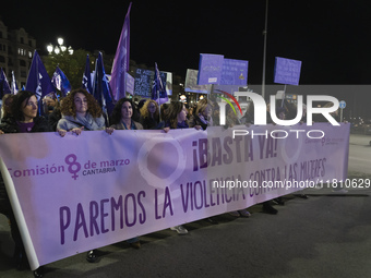 A group of women with a banner reading ''Enough, let's stop violence against women'' leads the demonstration for the International Day for t...