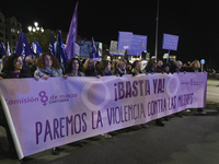 A group of women with a banner reading ''Enough, let's stop violence against women'' leads the demonstration for the International Day for t...