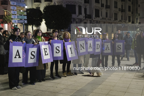 A group of women with signs reading ''murdered'' take part in the demonstration for the International Day for the Elimination of Violence ag...