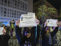 Women carry obituaries of women killed during the demonstration for the International Day for the Elimination of Violence against Women in t...