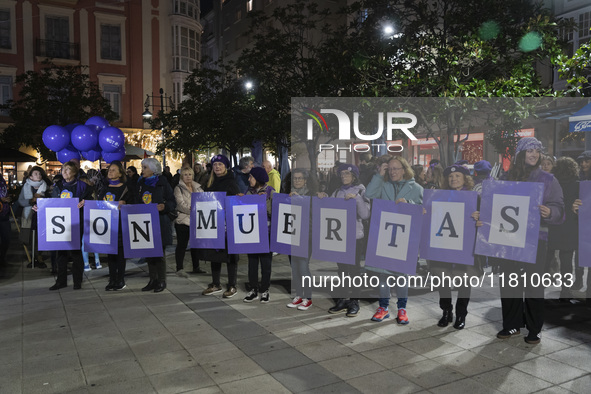 A group of women carry signs reading ''They are dead'' during the demonstration for the International Day for the Elimination of Violence ag...