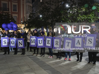 A group of women carry signs reading ''They are dead'' during the demonstration for the International Day for the Elimination of Violence ag...