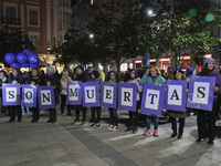 A group of women carry signs reading ''They are dead'' during the demonstration for the International Day for the Elimination of Violence ag...