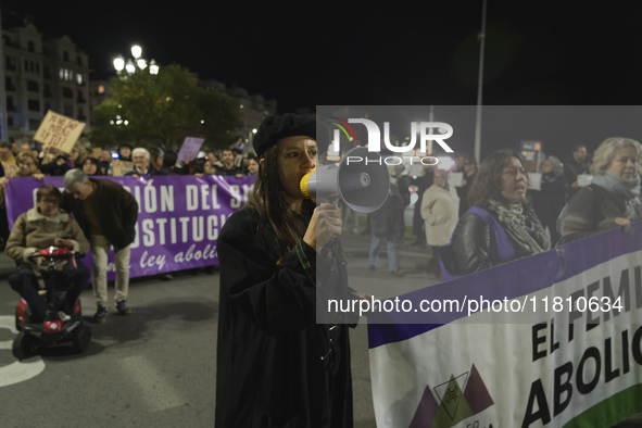 A young woman with a megaphone shouts slogans against sexism during the demonstration for the International Day for the Elimination of Viole...