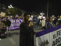 A young woman with a megaphone shouts slogans against sexism during the demonstration for the International Day for the Elimination of Viole...