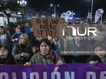 A woman holds a sign that says ''I'm not a pimp and you?'' demanding the abolition of prostitution during the demonstration for the Internat...