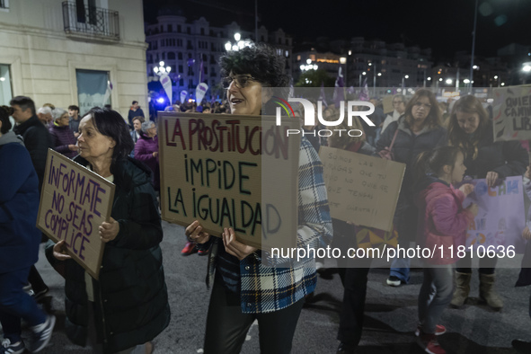 A woman holds a sign reading ''Prostitution prevents equality'' and demands the abolition of prostitution during a demonstration for the Int...