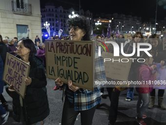 A woman holds a sign reading ''Prostitution prevents equality'' and demands the abolition of prostitution during a demonstration for the Int...