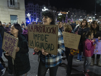 A woman holds a sign reading ''Prostitution prevents equality'' and demands the abolition of prostitution during a demonstration for the Int...