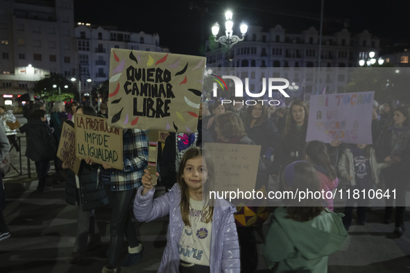 A girl holds a banner reading ''I want to walk free'' during the demonstration for the International Day for the Elimination of Violence aga...