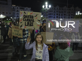 A girl holds a banner reading ''I want to walk free'' during the demonstration for the International Day for the Elimination of Violence aga...