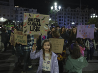 A girl holds a banner reading ''I want to walk free'' during the demonstration for the International Day for the Elimination of Violence aga...