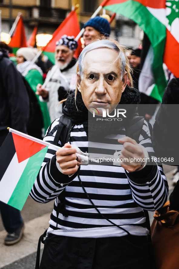 Demonstrators wear a mask of Benjamin Netanyahu during a pro-Palestinian protest in Piazza Duomo in Milan, Italy, on November 23, 2024 