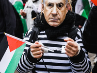 Demonstrators wear a mask of Benjamin Netanyahu during a pro-Palestinian protest in Piazza Duomo in Milan, Italy, on November 23, 2024 (