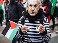 Demonstrators wear a mask of Benjamin Netanyahu during a pro-Palestinian protest in Piazza Duomo in Milan, Italy, on November 23, 2024 (