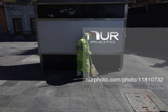 A cleaning worker is on the streets of the Zocalo in Mexico City, Mexico, on November 25, 2024, which coincides with the International Day f...