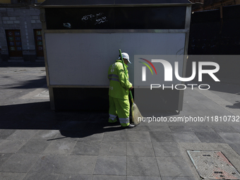 A cleaning worker is on the streets of the Zocalo in Mexico City, Mexico, on November 25, 2024, which coincides with the International Day f...