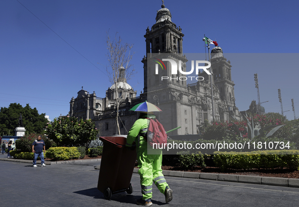 A cleaning worker is on the streets of the Zocalo in Mexico City, Mexico, on November 25, 2024, which coincides with the International Day f...