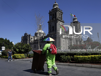 A cleaning worker is on the streets of the Zocalo in Mexico City, Mexico, on November 25, 2024, which coincides with the International Day f...