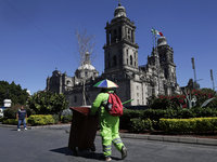 A cleaning worker is on the streets of the Zocalo in Mexico City, Mexico, on November 25, 2024, which coincides with the International Day f...