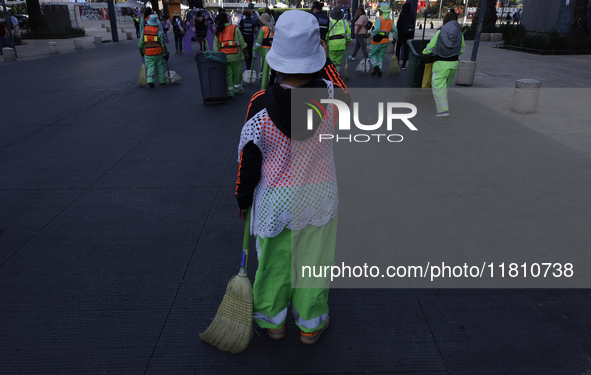 A cleaning worker is on the streets of the Zocalo in Mexico City, Mexico, on November 25, 2024, which coincides with the International Day f...