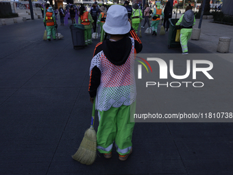 A cleaning worker is on the streets of the Zocalo in Mexico City, Mexico, on November 25, 2024, which coincides with the International Day f...