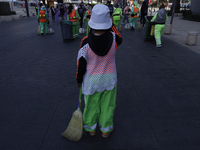 A cleaning worker is on the streets of the Zocalo in Mexico City, Mexico, on November 25, 2024, which coincides with the International Day f...