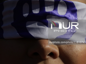 A woman protests in Mexico City, Mexico, on November 25, 2024, on the occasion of the International Day for the Elimination of Violence agai...