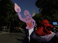 Mothers, relatives of missing persons and victims of femicide, feminist collectives, and various organizations hold silhouettes while protes...